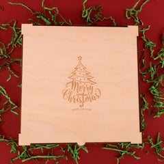 Beige gift box with 'Merry Christmas' and 'Happy New Year' text on a red background with green decorative elements.
