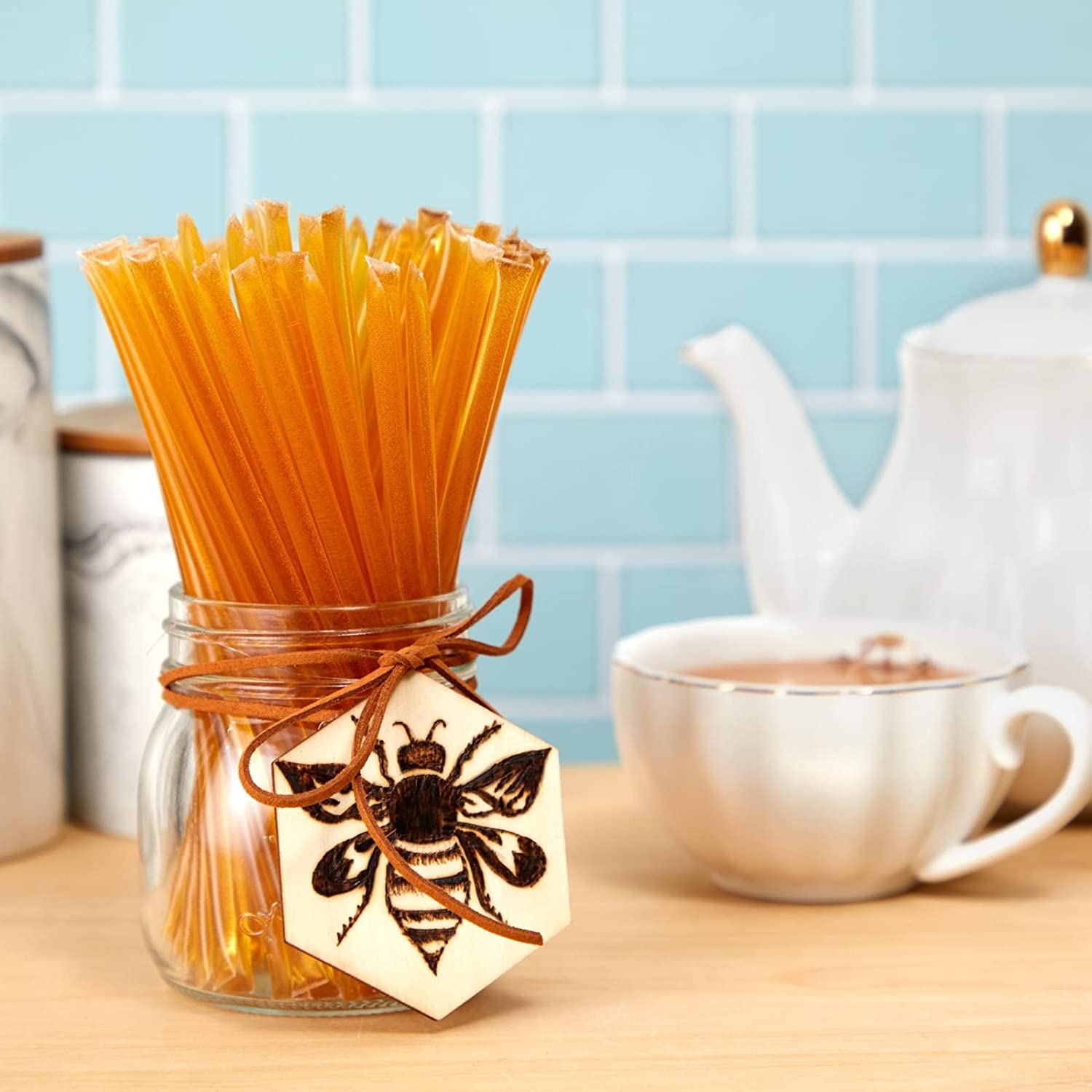 Jar of coffee filters with a bee design on a kitchen counter