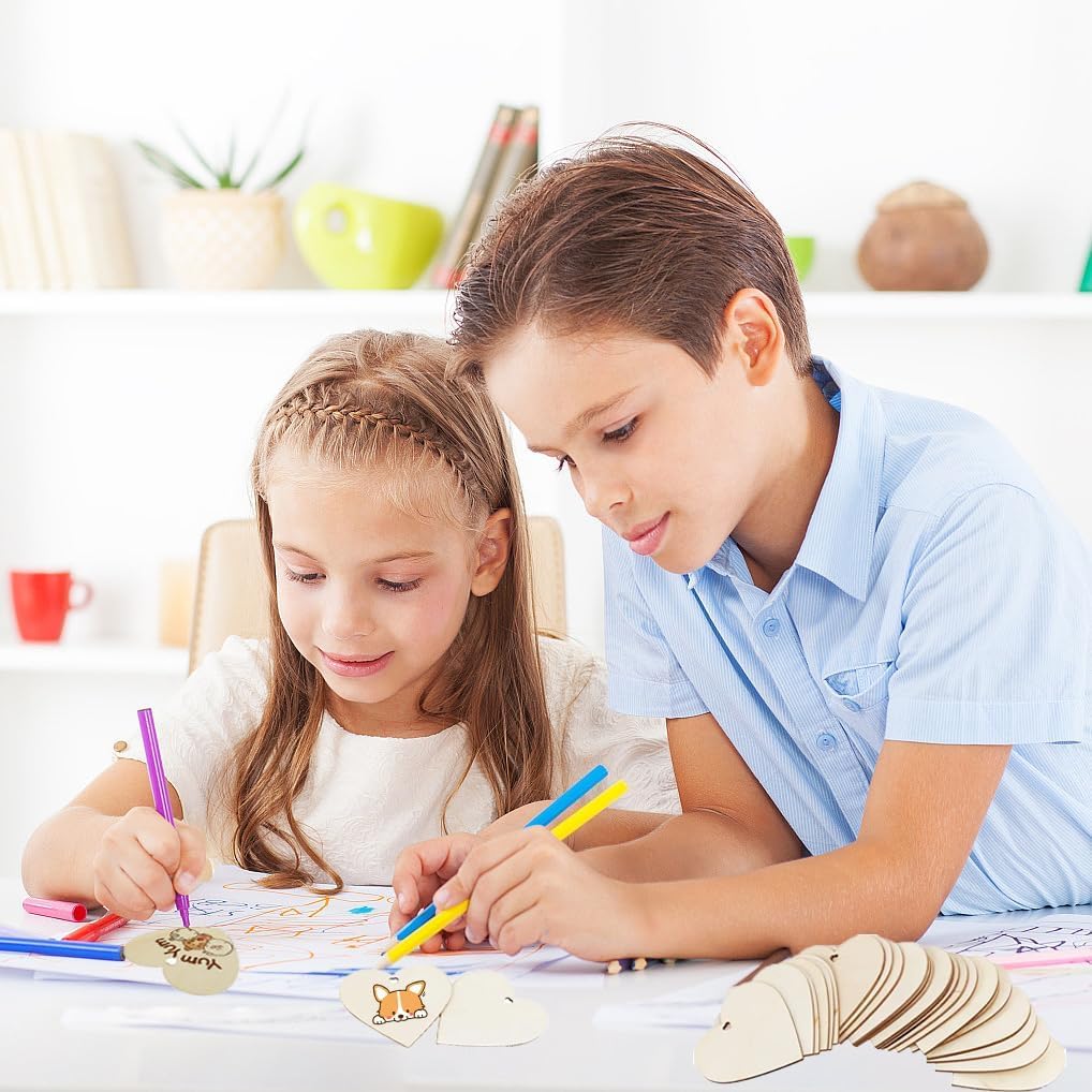 Two children coloring at a table with crayons and paper.