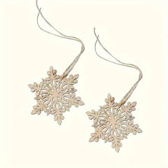 Two wooden snowflake ornaments on strings against a white background