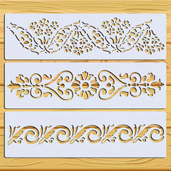 Three decorative stencils with intricate patterns on a wooden surface