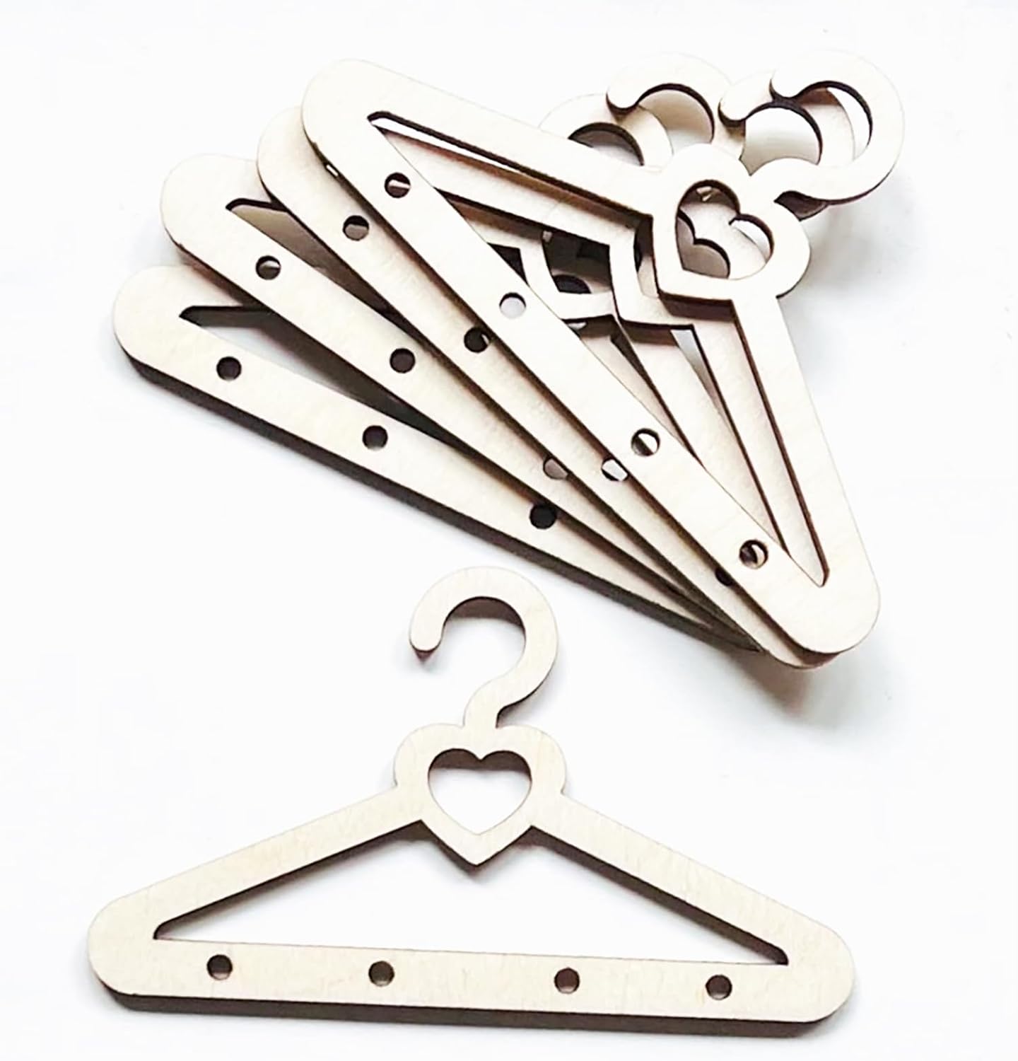 Set of wooden hangers with decorative heart and moon designs on a white background