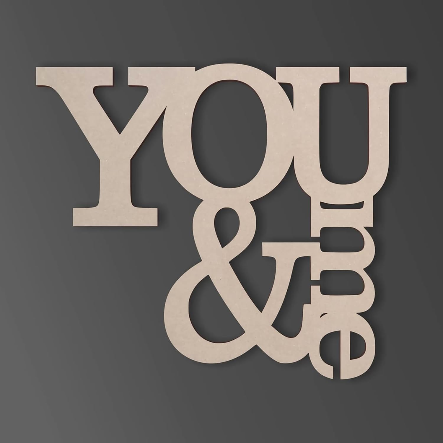 Wooden letters spelling 'YOU & I' on a dark background