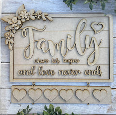 Decorative wooden sign with 'Family where life begins and love never ends' text on a wooden background.