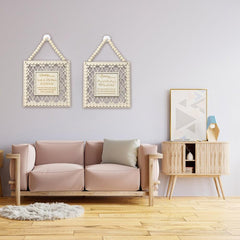 Modern living room with a pink sofa, wooden side table, and decorative wall art.