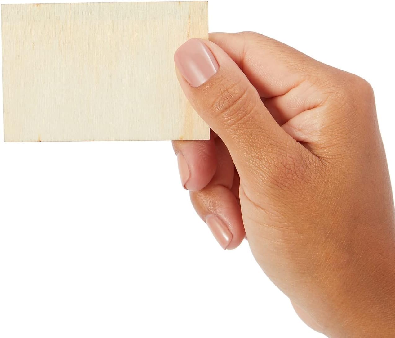 Hand holding a small yellow sticky note against a white background