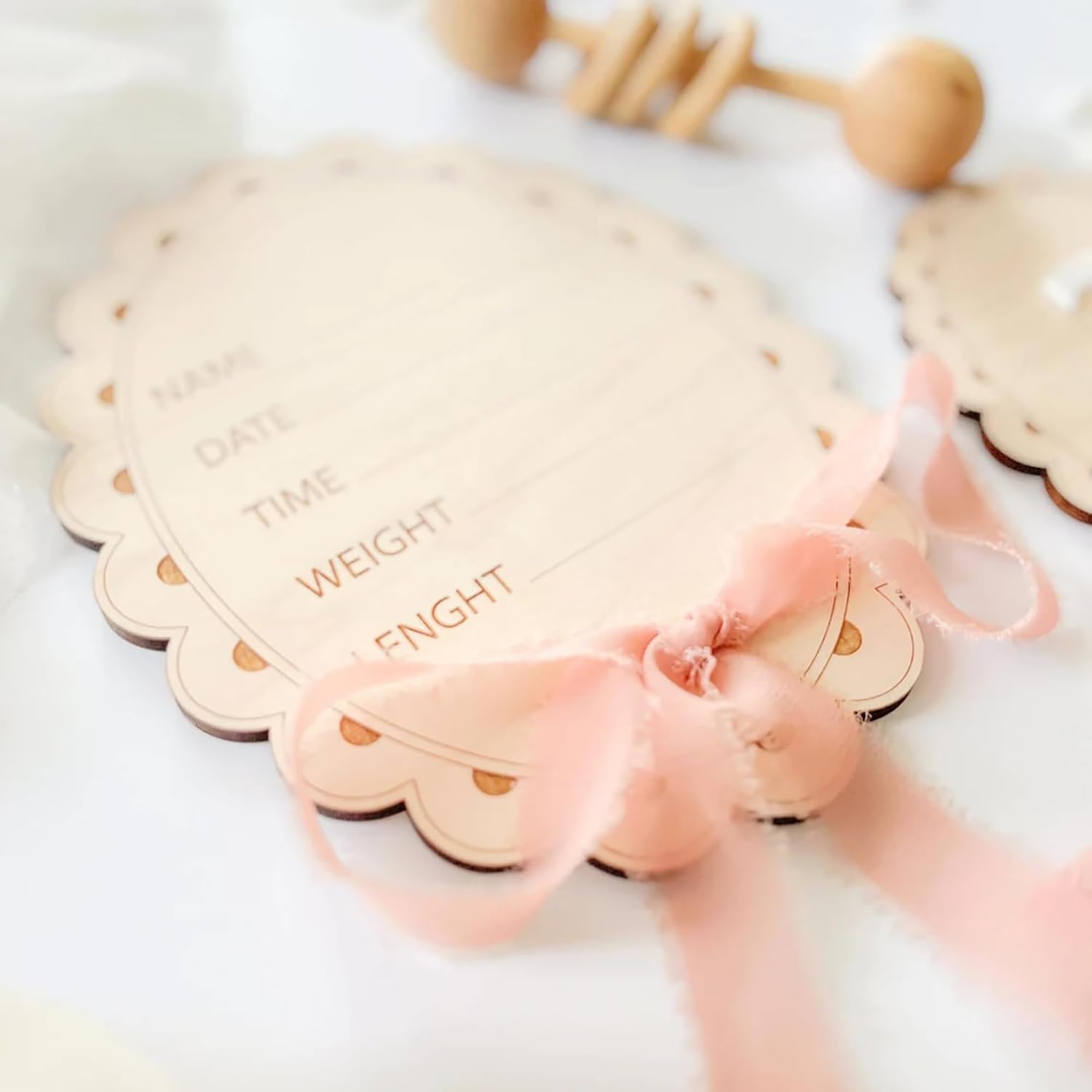 Baby weight chart with pink ribbon on a white background