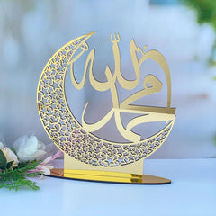 Decorative metal crescent moon with Arabic calligraphy on a stand, blurred floral background