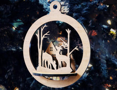 Wooden ornament with deer and cabin design against a blurred forest background