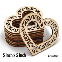 Stack of wooden heart-shaped cutouts with intricate designs on a white background.