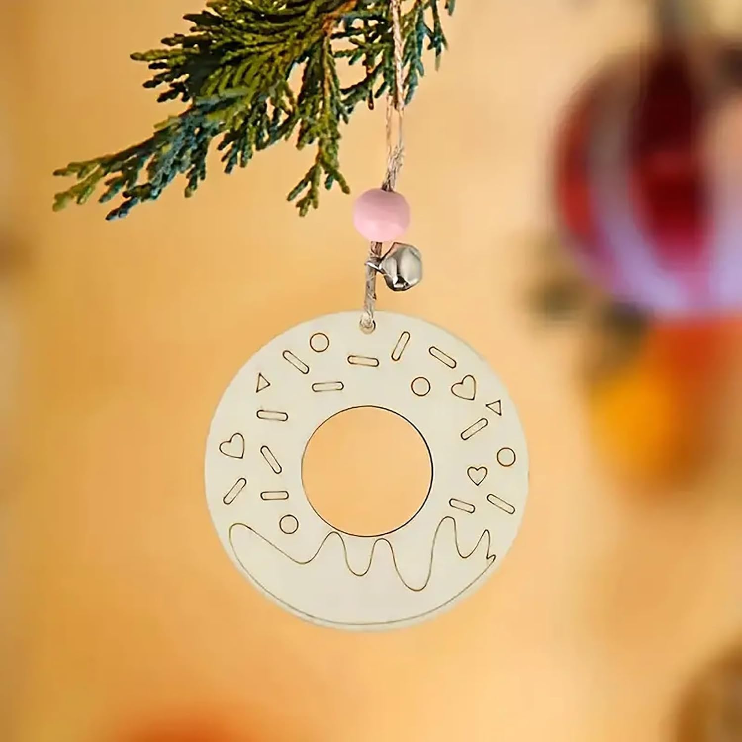 Decorative donut ornament hanging on a tree with a blurred background