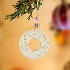Decorative donut ornament hanging on a tree with a blurred background