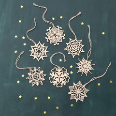 Decorative snowflake ornaments on a dark background with small stars.