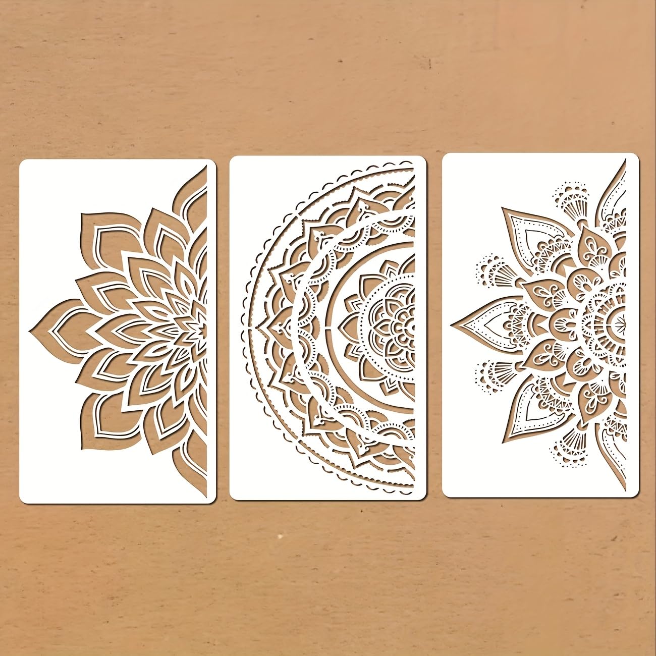 Three decorative stencils with intricate patterns on a beige background