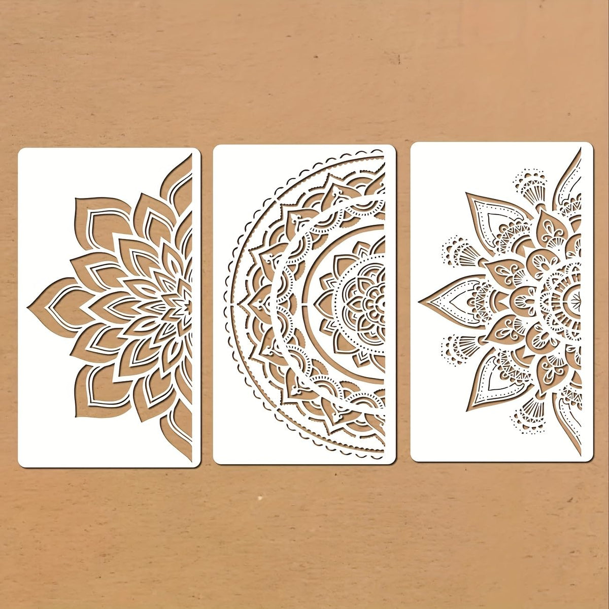 Three decorative stencils with intricate patterns on a beige background