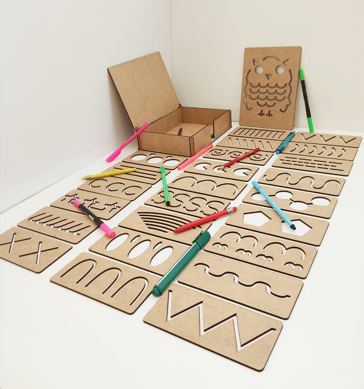 Cardboard tracing boards with tools on a white surface