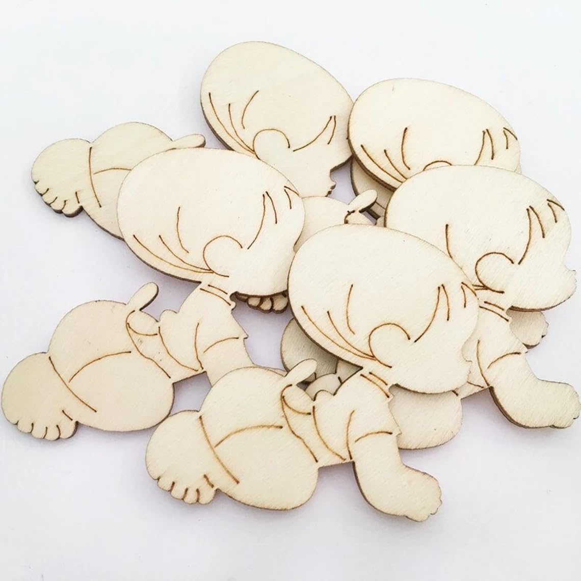 Wooden cutouts of cartoon characters on a white background
