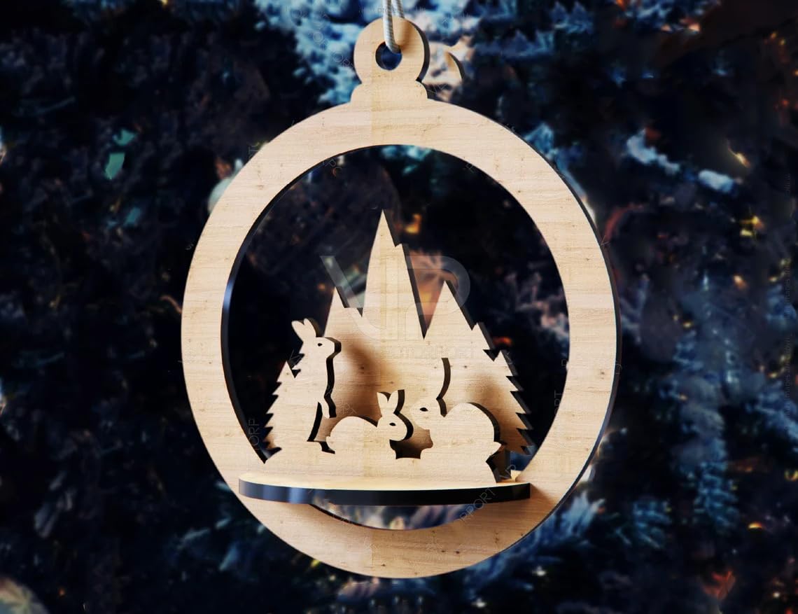 Wooden Christmas ornament with cut-out design of a snowy landscape and trees against a dark background.
