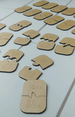 Set of wooden puzzle pieces with letter embossing on a light gray surface