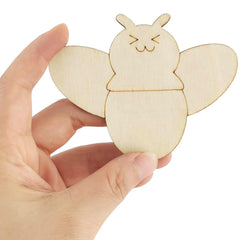 Hand holding a wooden bee-shaped object against a white background