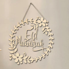 Decorative wall hanging with 'Eid Mubarak' text on a beige background