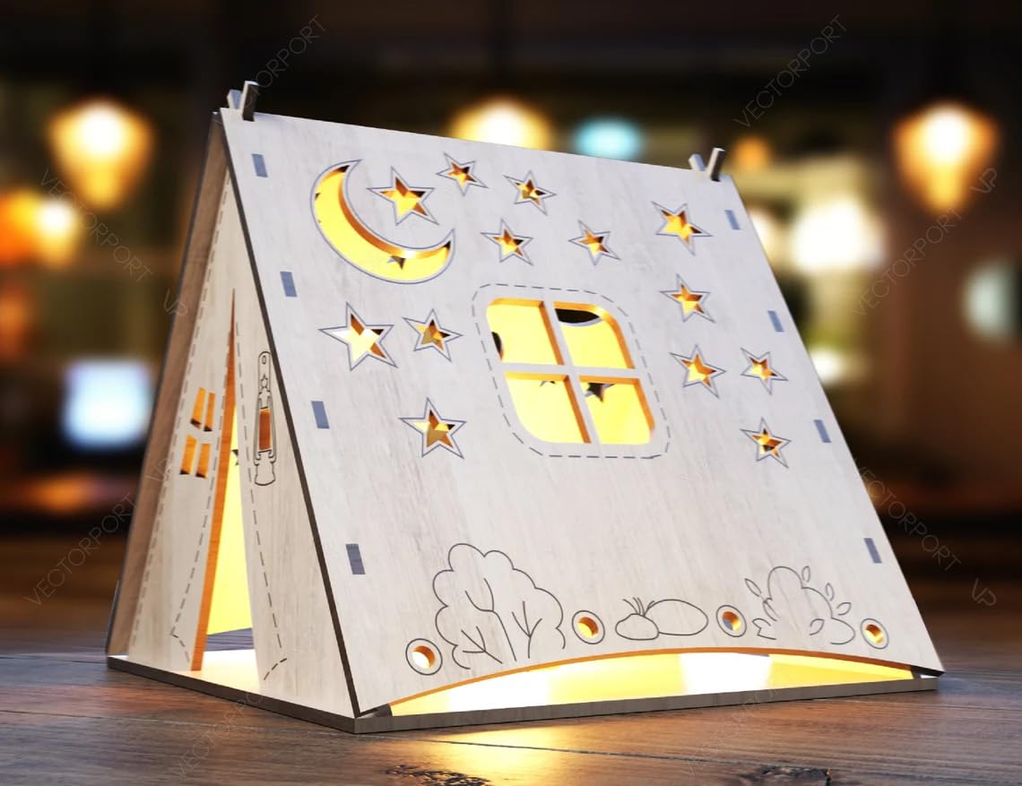 Decorative night light shaped like a house with stars and moon on a wooden surface.