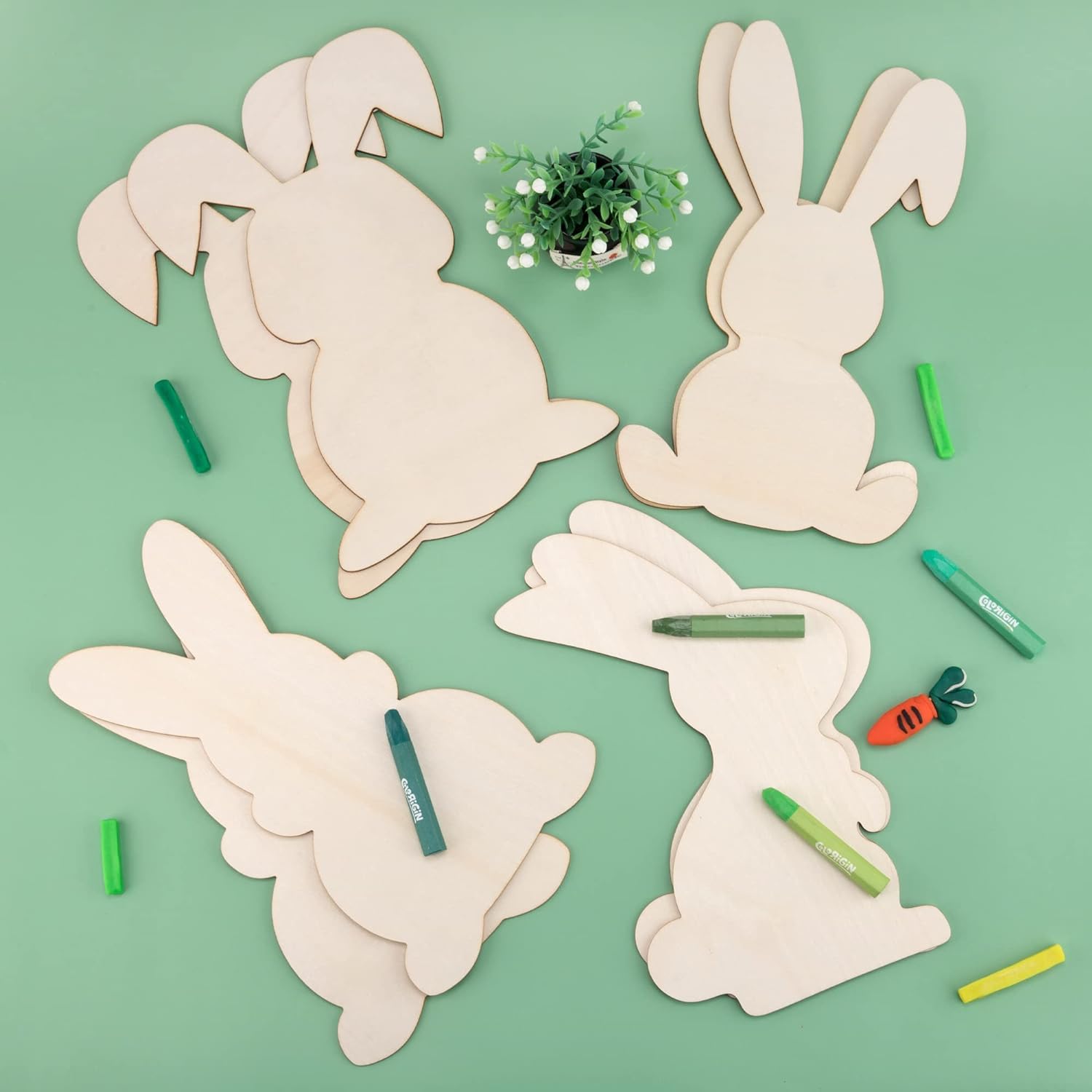 Wooden bunny shapes with markers on a green background