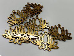 Gold floral-shaped metal decorations on a gray background