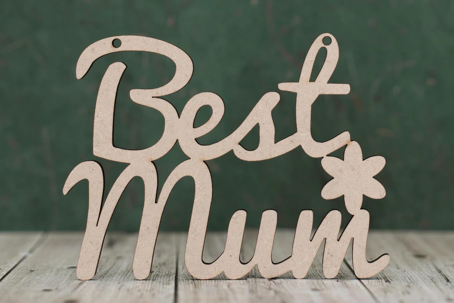 Wooden decorative sign with 'Best Mum' text on a wooden surface and dark background