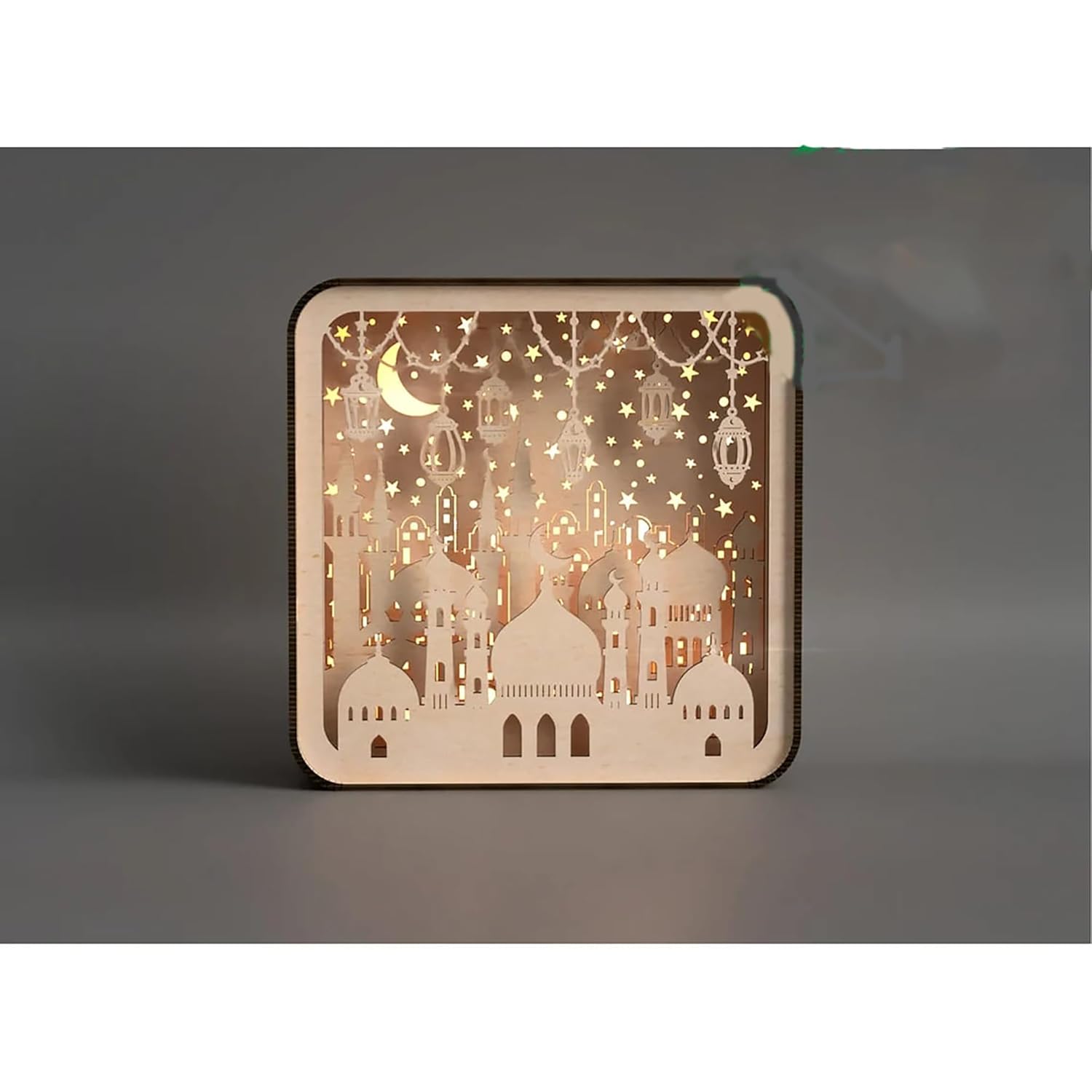 Decorative wooden panel with cut-out designs of buildings and stars on a dark background