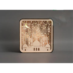 Decorative wooden panel with cut-out designs of buildings and stars on a dark background