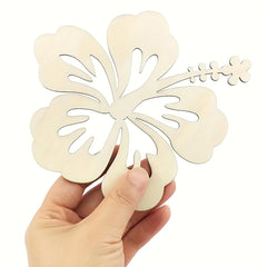 Hand holding a decorative wooden leaf cutout against a white background