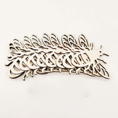 Wooden cutout shapes of unicorns on a white background
