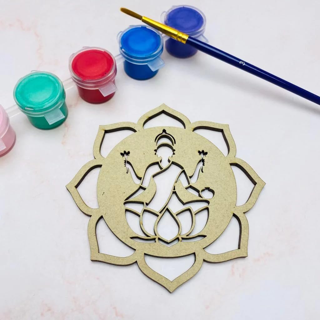 Decorative wooden cutout of a seated figure with lotus flowers, surrounded by paint containers and a brush on a light background.