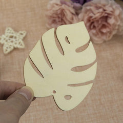 Hand holding a cut-out leaf shape against a floral background