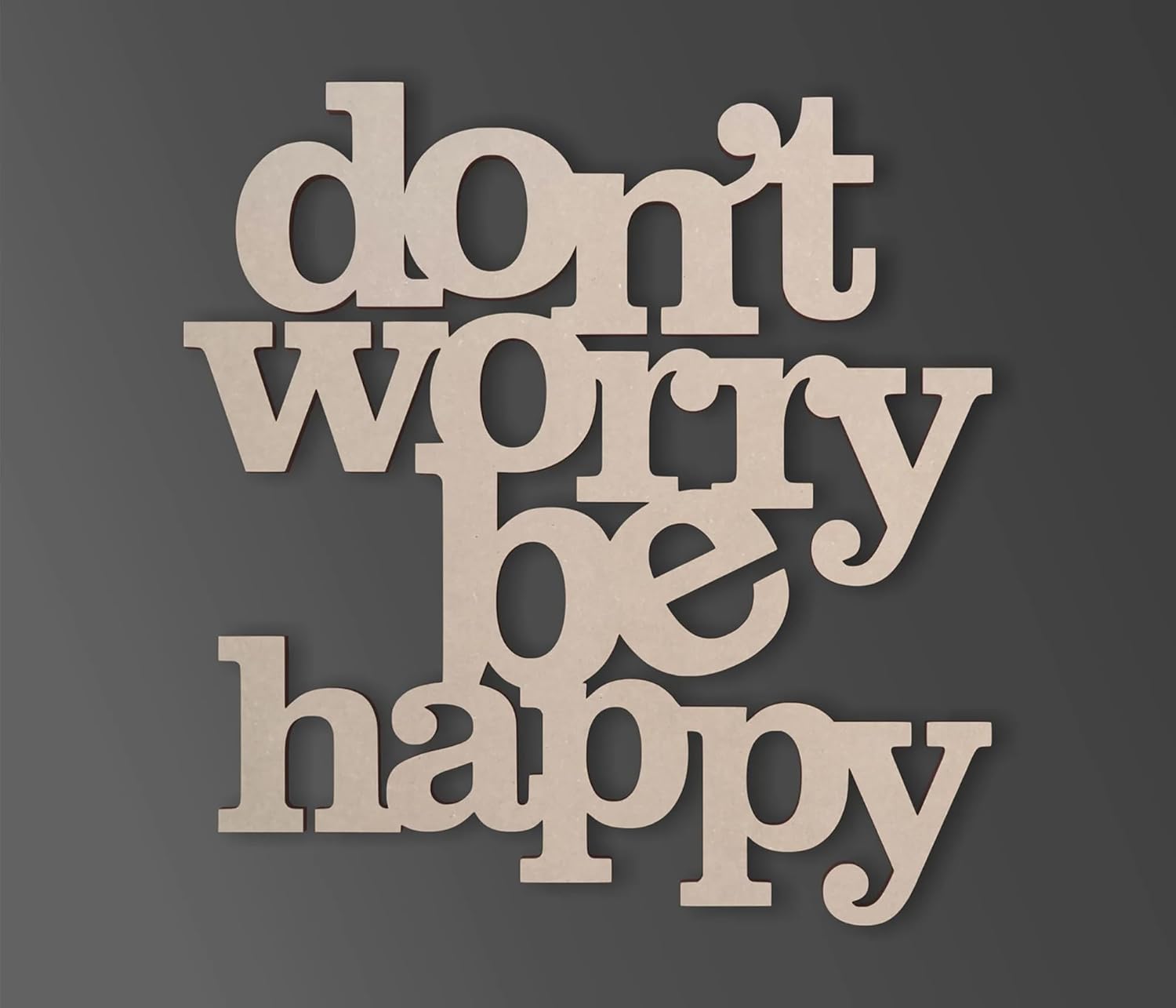 Wooden cutout letters spelling 'don't worry be happy' on a dark background
