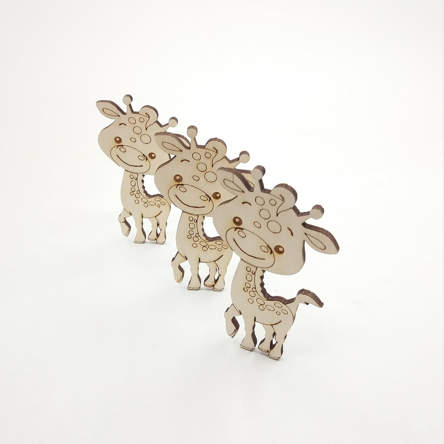 Three wooden giraffe toys on a white background