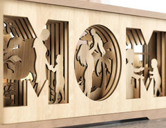 Decorative wall panel with cut-out silhouettes of people and animals on a beige background