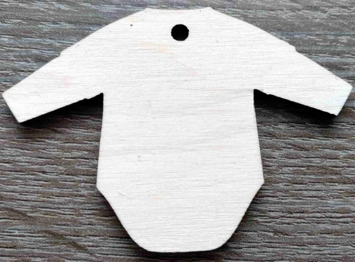White baby onesie-shaped tag on a wooden surface