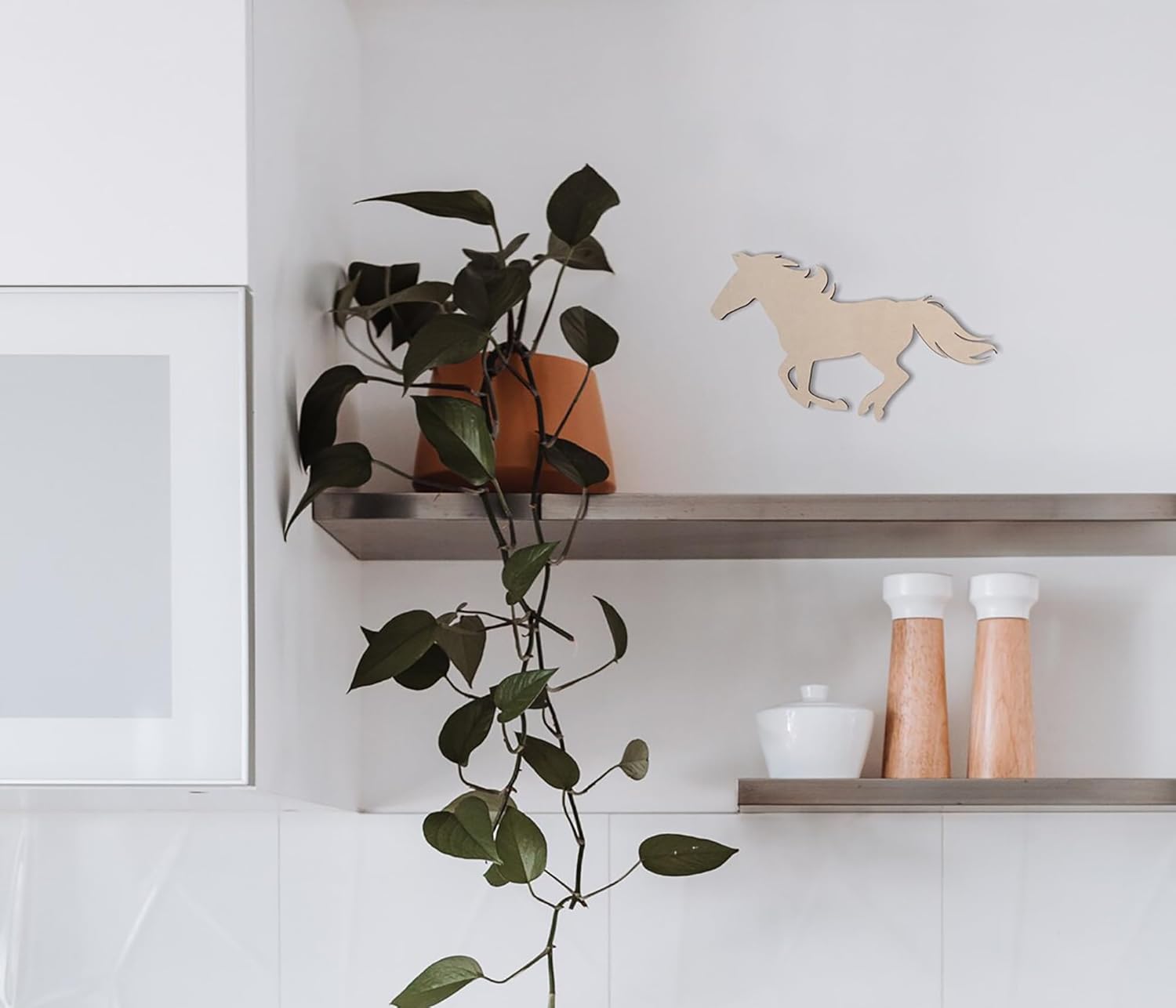 Shelving unit with a plant, decorative horse figure, and kitchen items.