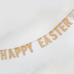Wooden 'Happy Easter' banner on a white background