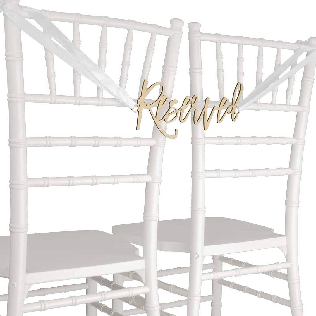 White chairs with gold 'Reserved' sign on a white background