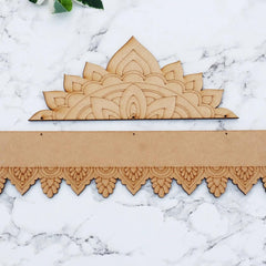 Decorative wooden cutouts with intricate patterns on a marble surface