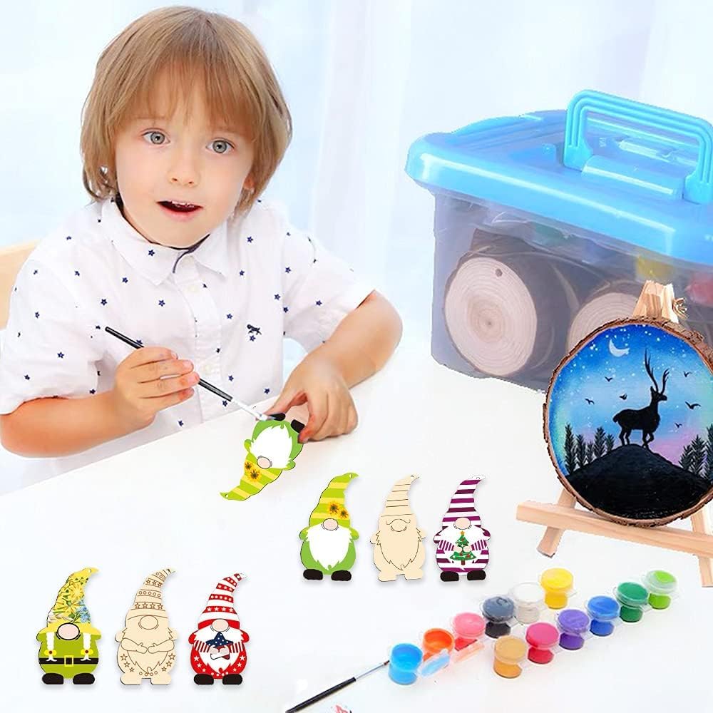 Child painting small figurines with a container of paint supplies and a painted wooden circle in the background.