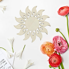 Decorative sun-shaped mirror with flowers on a white background