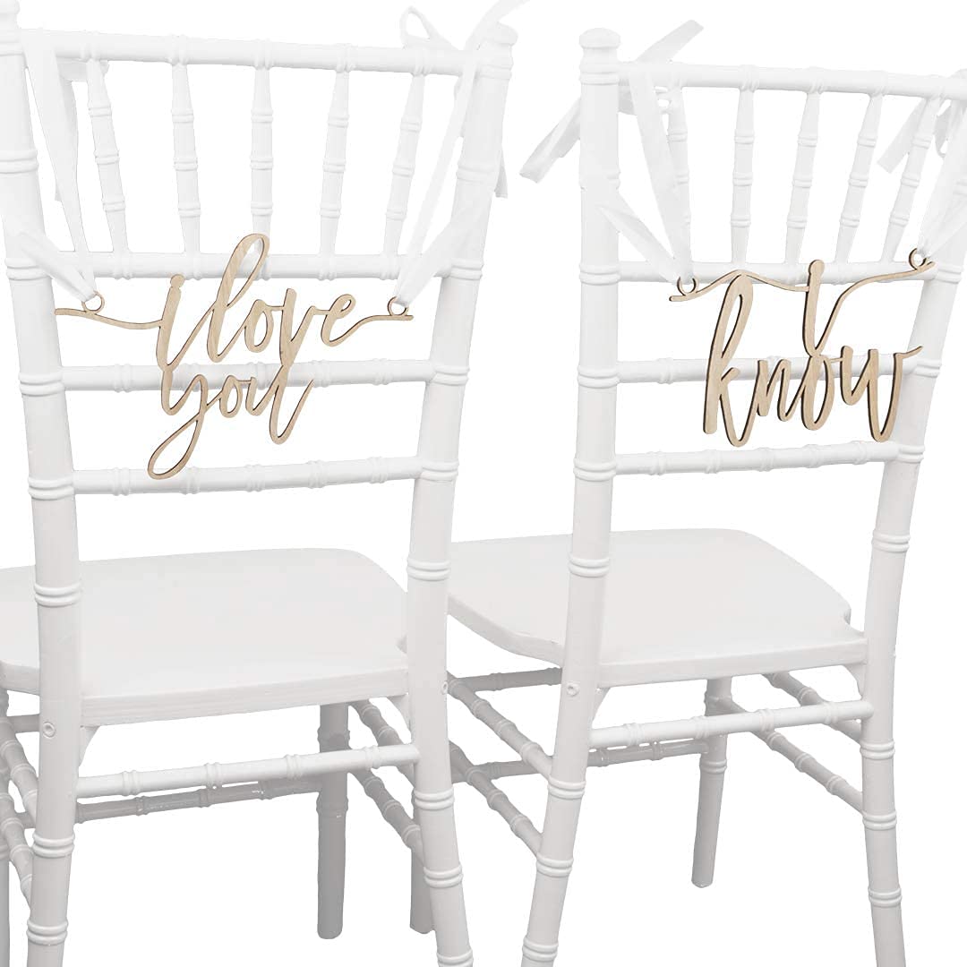 Two white chairs with gold 'I love you' and 'know' signs on a white background