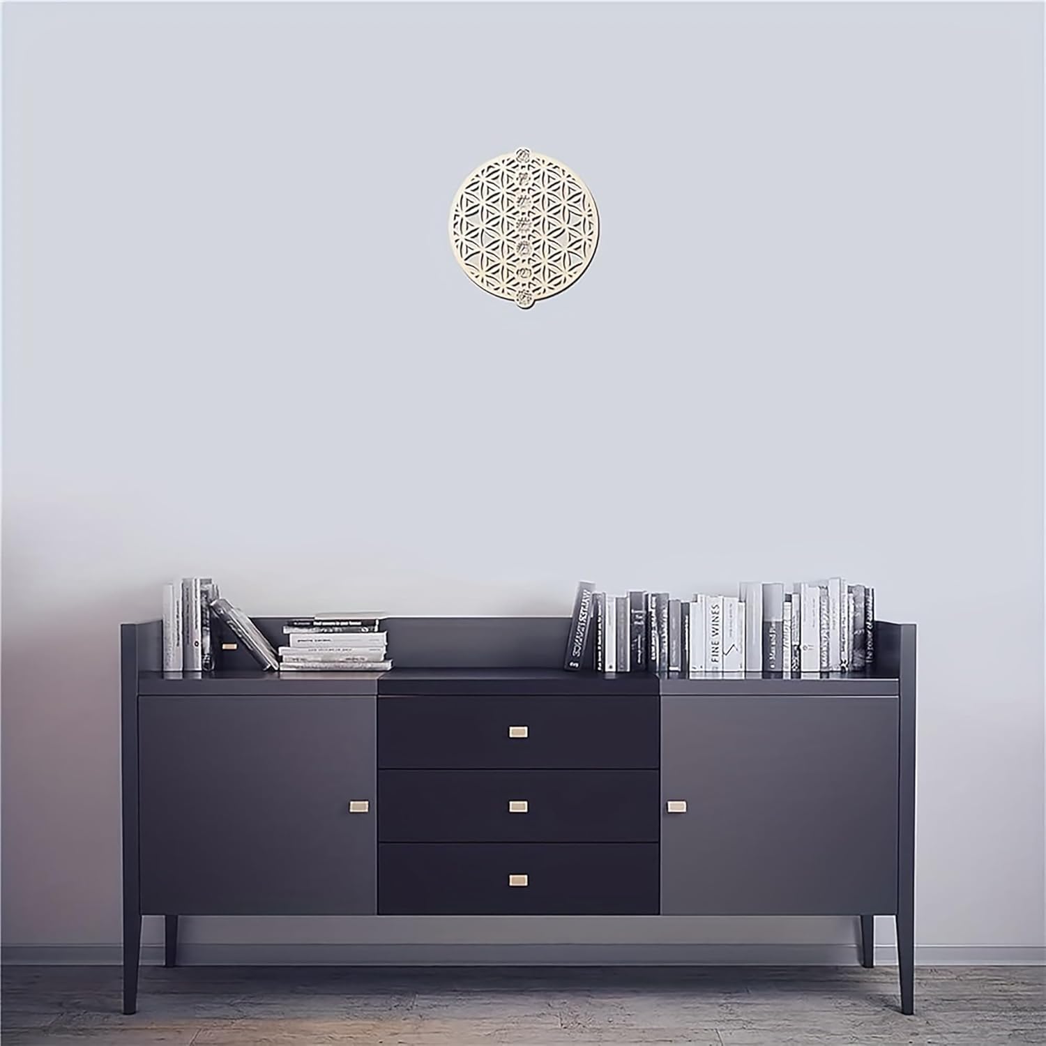 Dark gray sideboard with books against a light gray wall.