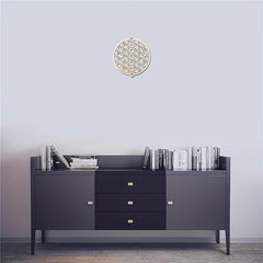 Dark gray sideboard with books against a light gray wall.