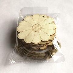 Stack of wooden flower-shaped cutouts with a string, still in packaging on a white background