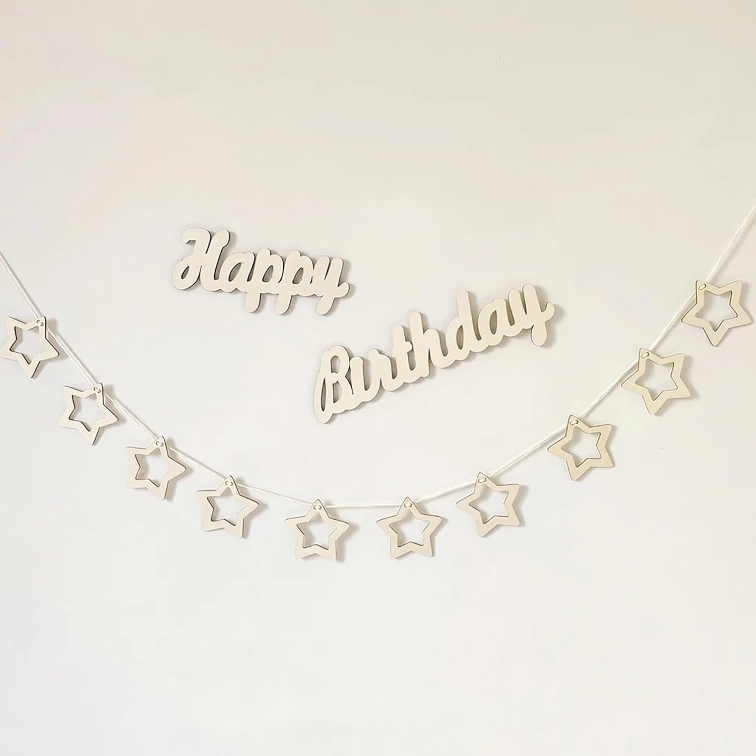 Wooden 'Happy Birthday' banner with star shapes on a white background